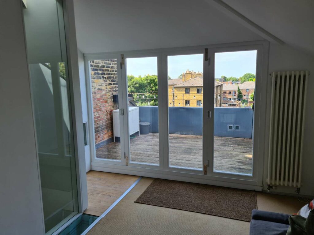 Closed timber bifold doors bringing natural light into a loft room