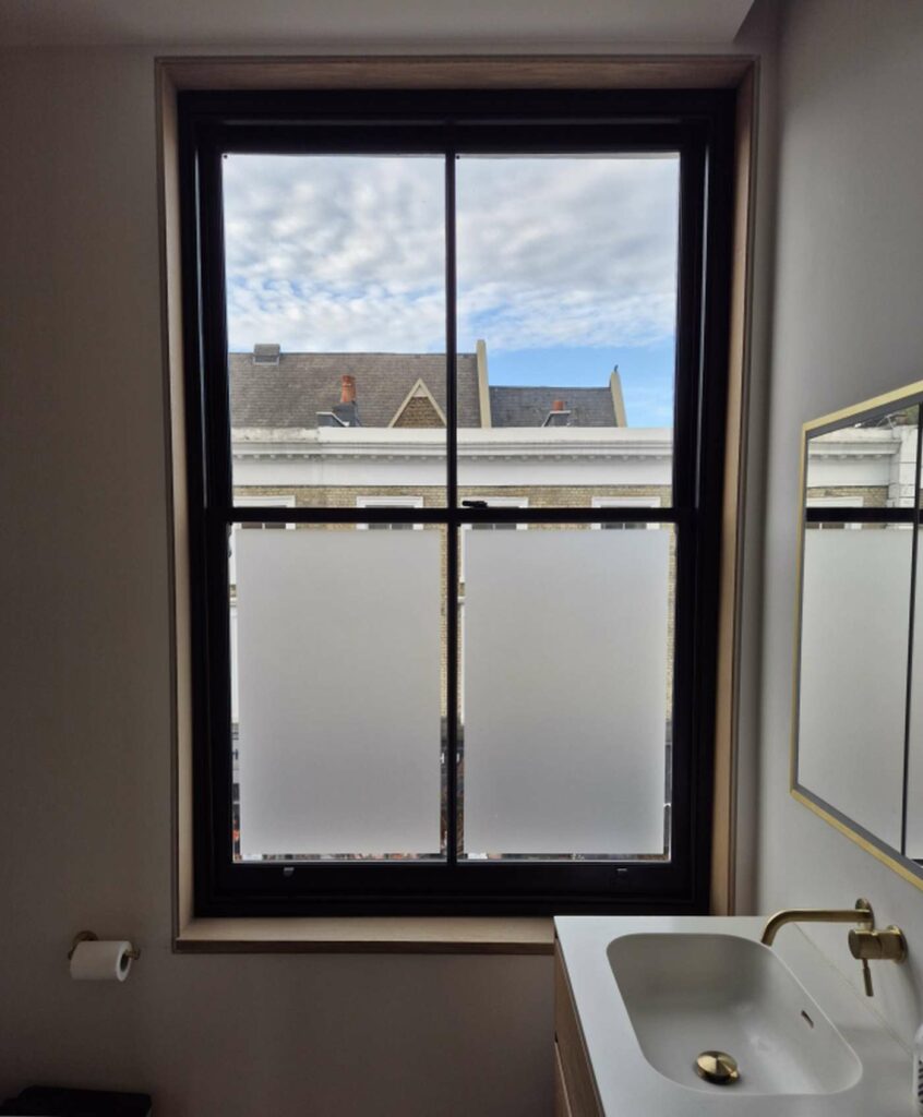 Completed black timber sash window with FINEO vacuum glazing in Notting Hill