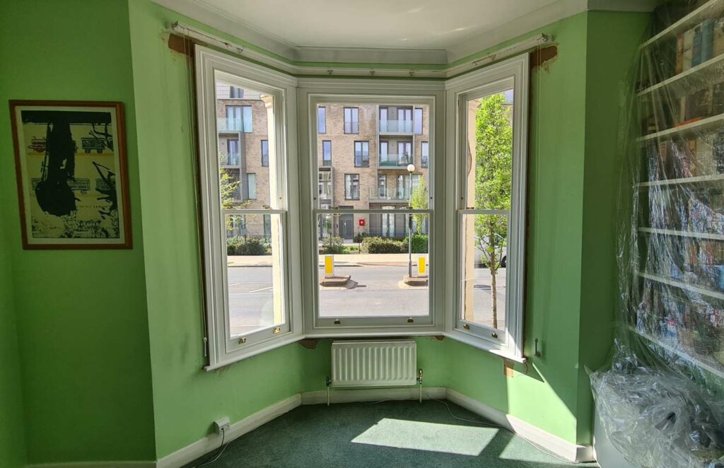 Completed timber bay sash windows in a London period room