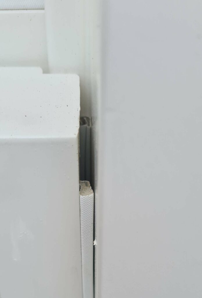 Concealed brush draught seal between a timber sash and frame