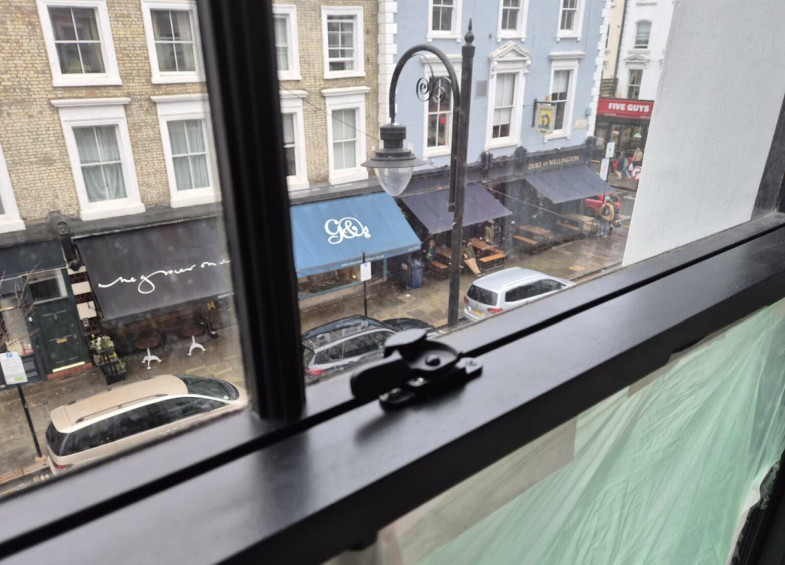 Black timber sash window with narrow sight lines in the Notting Hill project