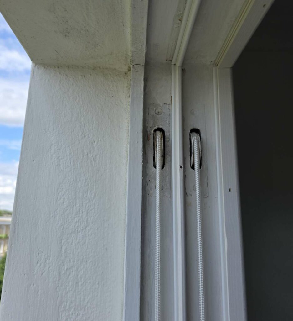 Sash cords running through a traditional timber box frame