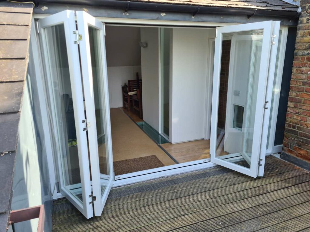 Timber bifold door panels folded open on both sides of the opening