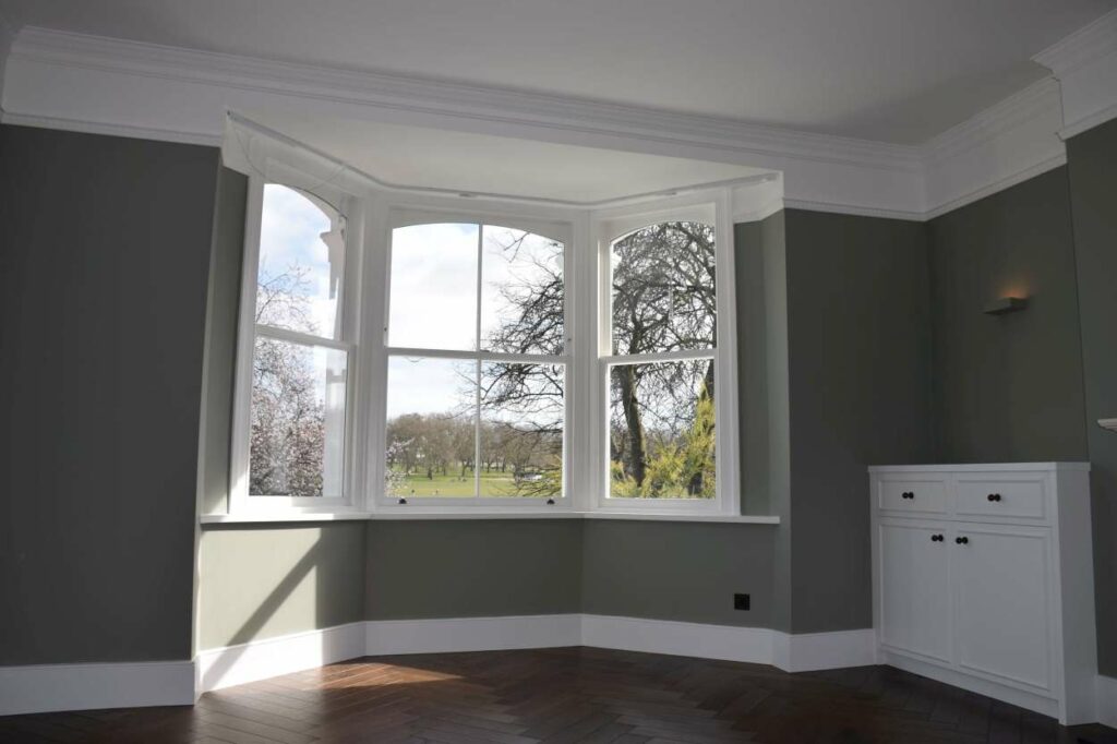 Three traditional timber sash windows forming a curved bay