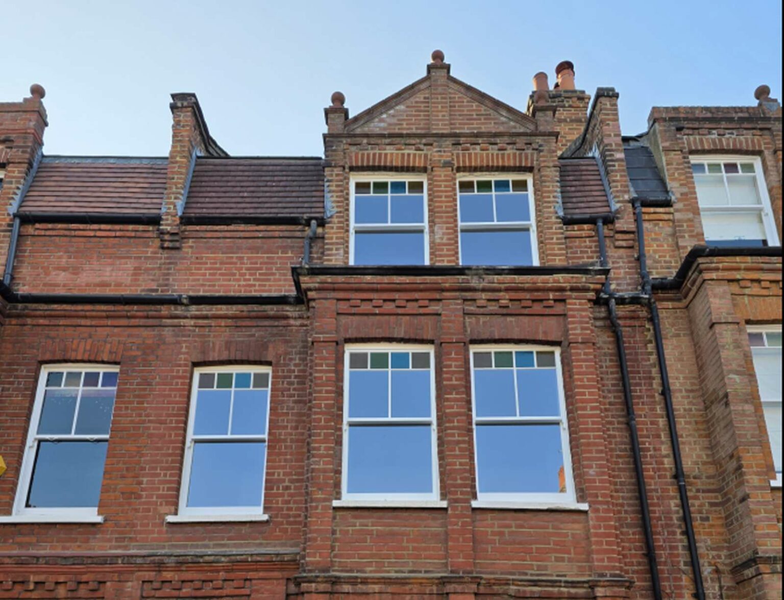 Victorian London house with timber sash windows and coloured top lights