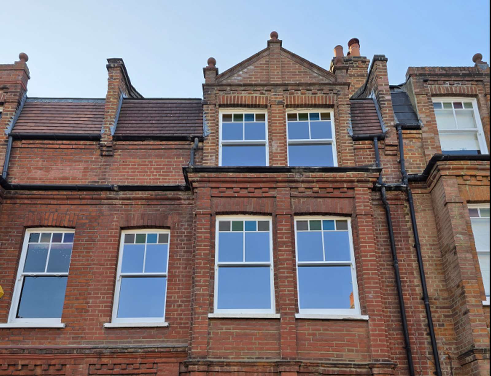 Victorian London house with timber sash windows and coloured top lights