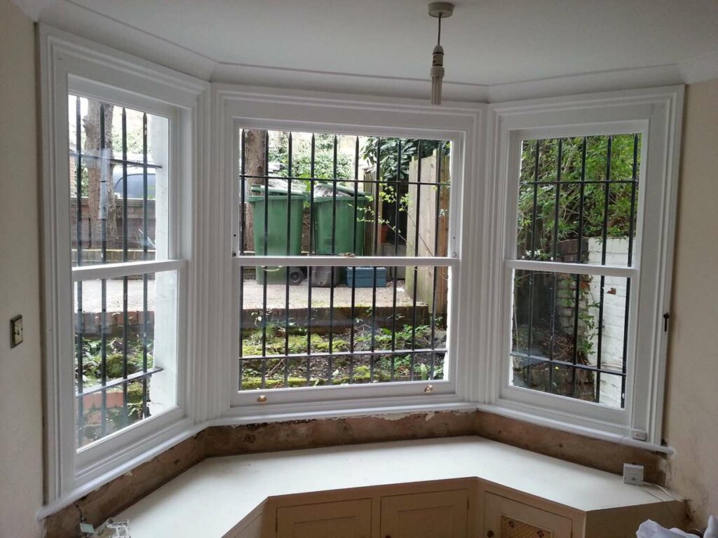 New glazed timber sashes fitted within a retained box frame