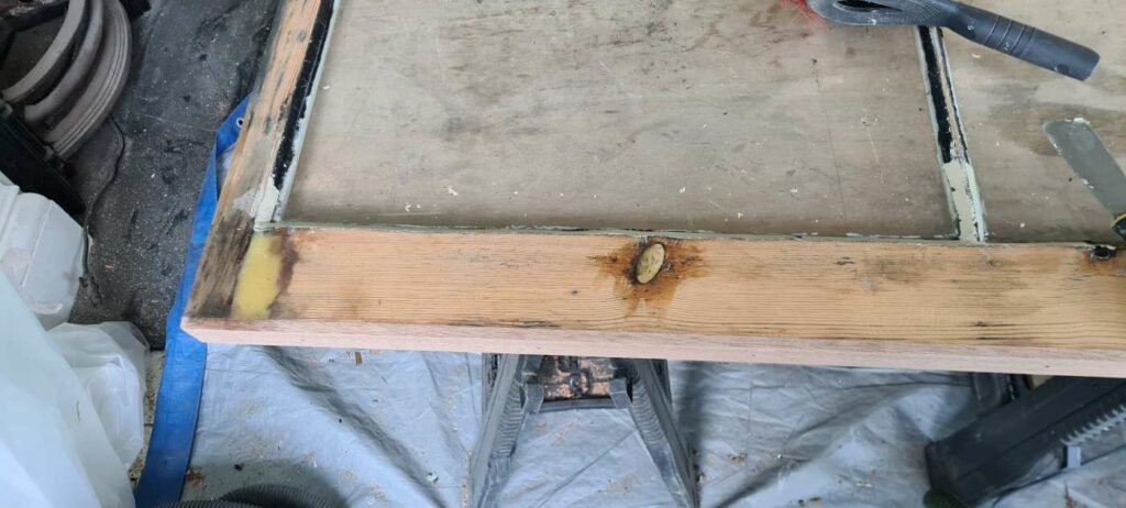 Exposed original timber and local repair areas on a sash window after paint removal