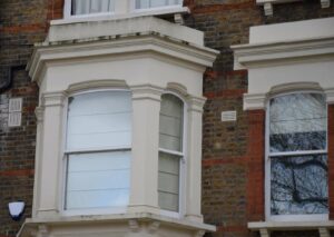 White timber bay sash windows on a London period brick façade