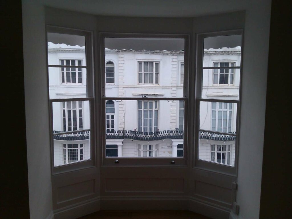 Timber bay sash window overlooking a London period streetscape