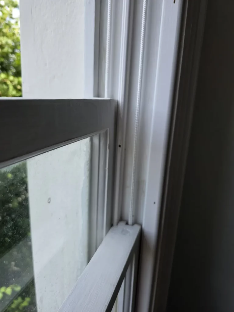 Refitted sash window with cords visible in the box frame