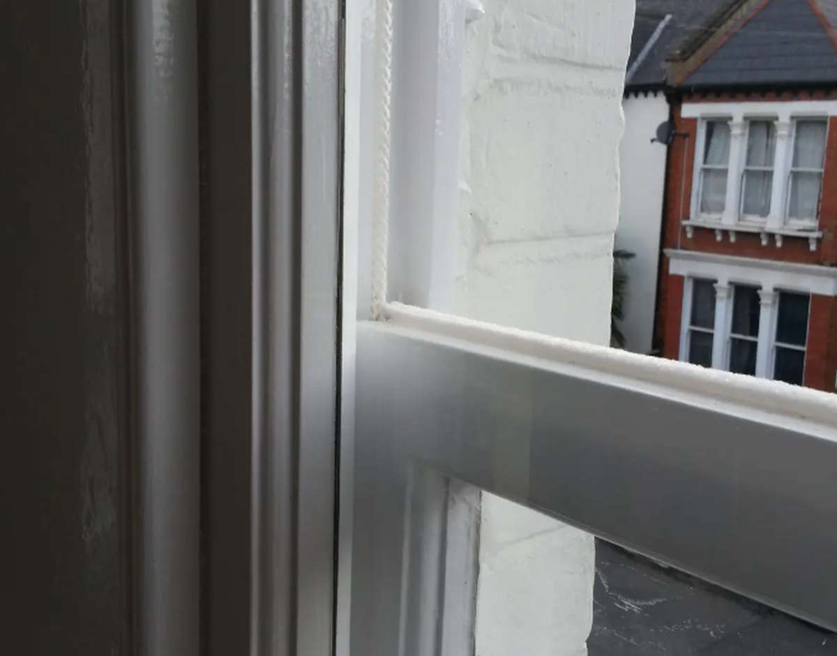 Open sash window with a visible sash cord