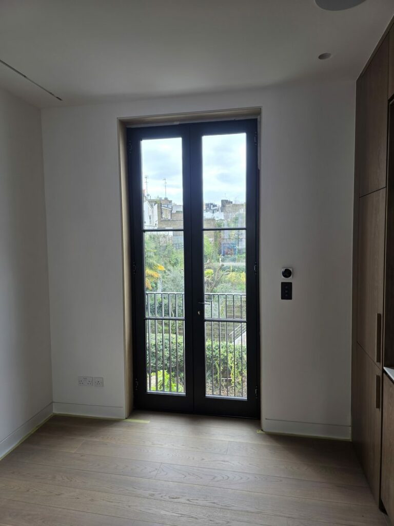 Dark-painted French doors with glazed panels viewed from inside
