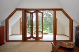 Timber bifold doors with large glazed side panels opening onto a garden terrace
